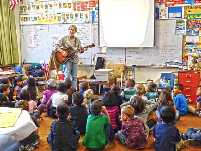 Here I am in a 1st grade classroom, helping students become better readers through music. I put the lyrics up on the screen and the kids “read along and sing along” with Mister Cooper. Thanks to Stephanie Rococha for taking the picture.